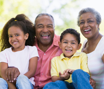 grandparents holding grandchildren all laughing