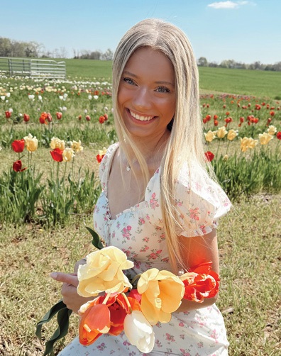 Franklin-Simpson Nursing and Rehab Activities Assistant, Crystal, pictured in field of flowers